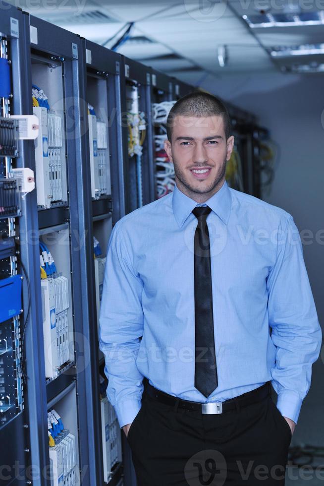 young it engineer in datacenter server room photo