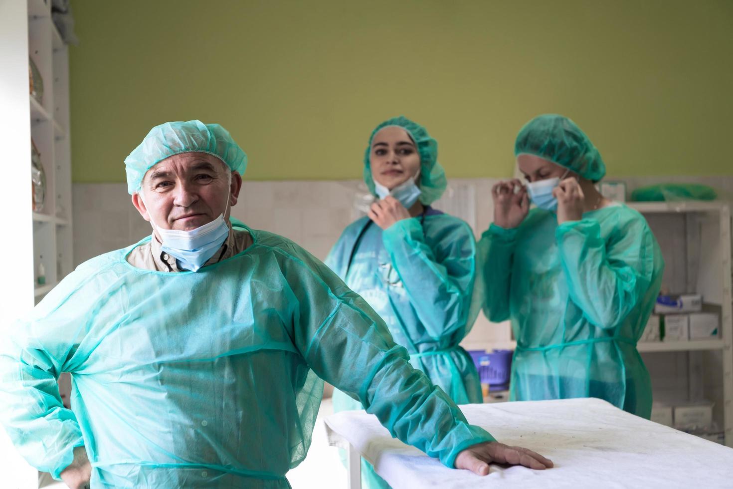 Portrait of doctors wearing uniform and preparing to doing surgical operation at the theater of hospital. Medical Concept. photo