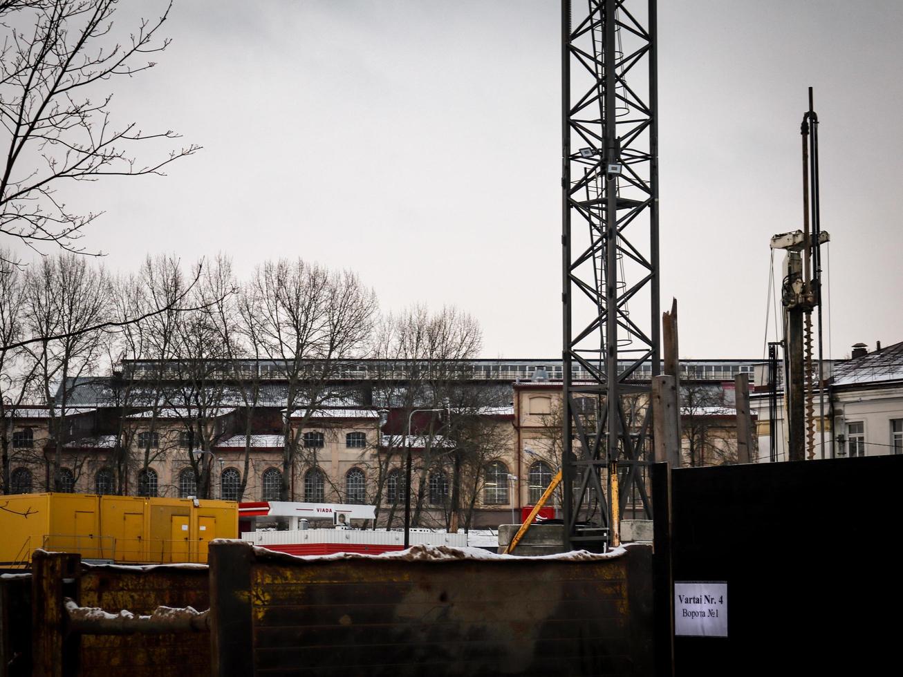 Vilnius, Lithuania, 2022 - The construction site on the old railway behind a fence with writing in two languages russian and lithuanian Gate Nr.4 photo