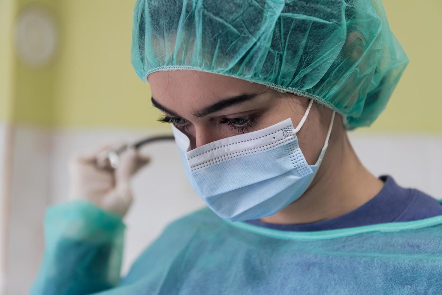 Portrait of sad and overwhelmed doctor wearing protective face mask, looking exhausted depressed and worried due to coronavirus outbreak. Emotional stressed, health care workers and COVID-19. photo