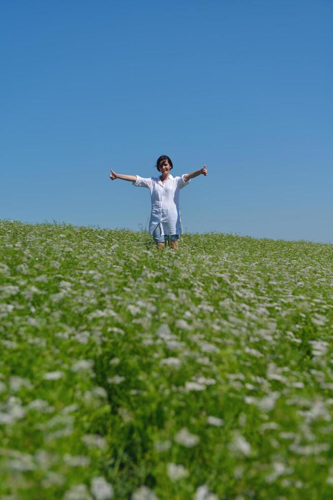 Young happy woman in green field photo