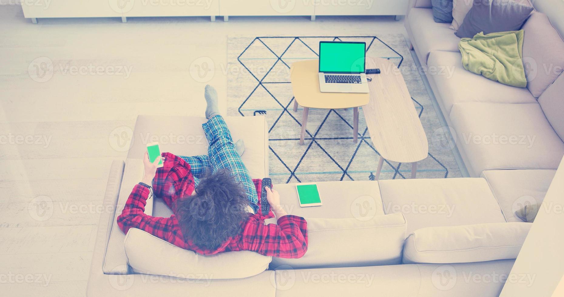 Young couple on the sofa watching television photo