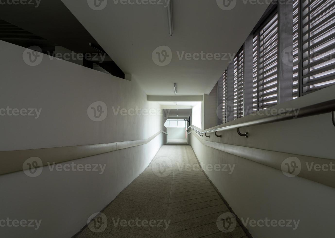 Light at the exit of the corridor in the building photo