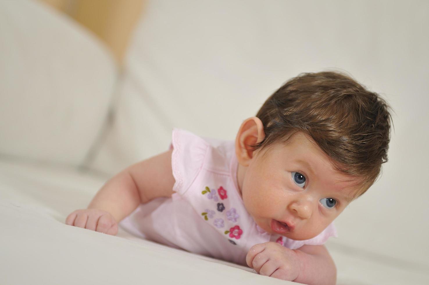 Baby crawling on ground photo