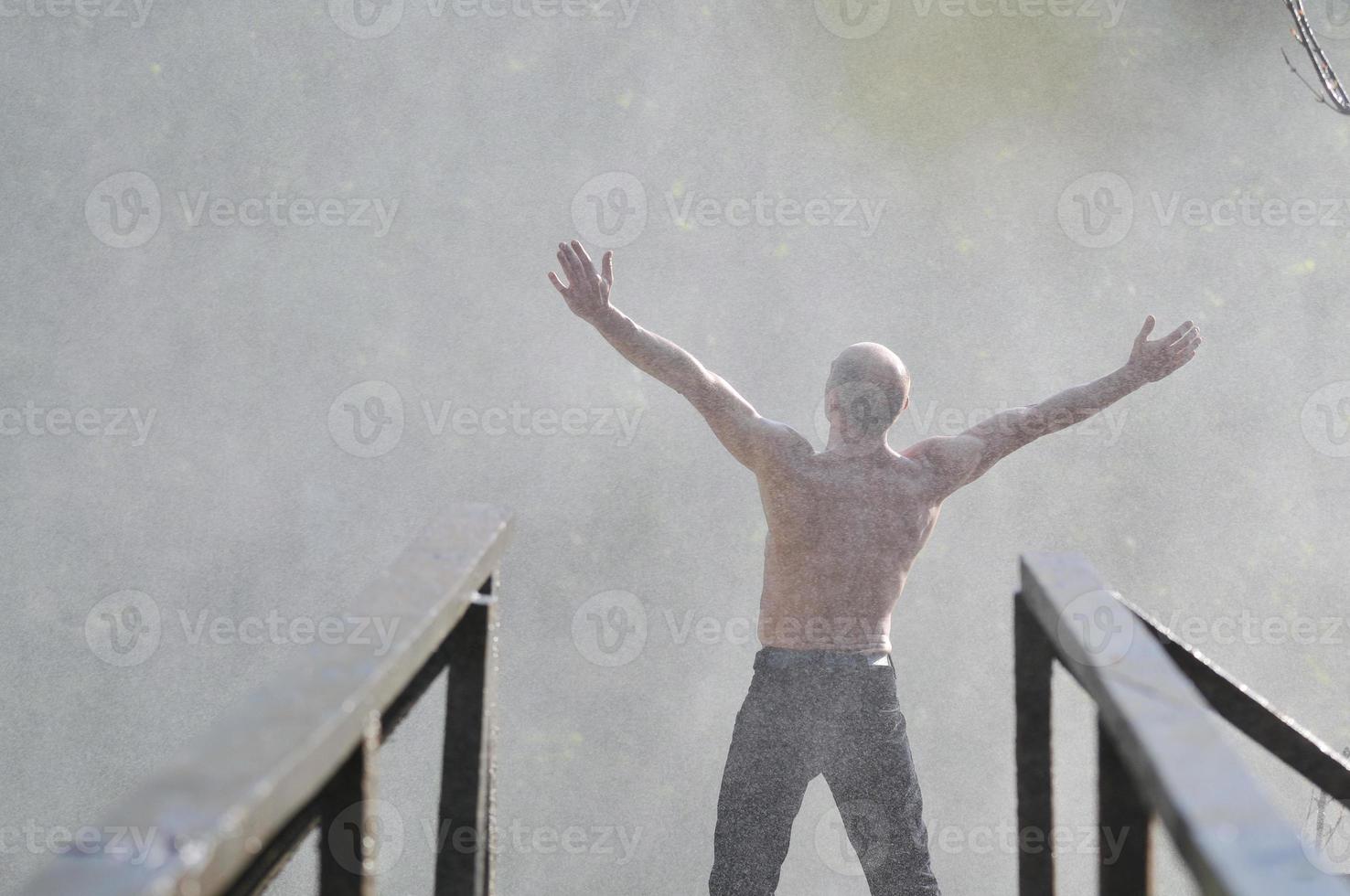 Man in waterfall photo