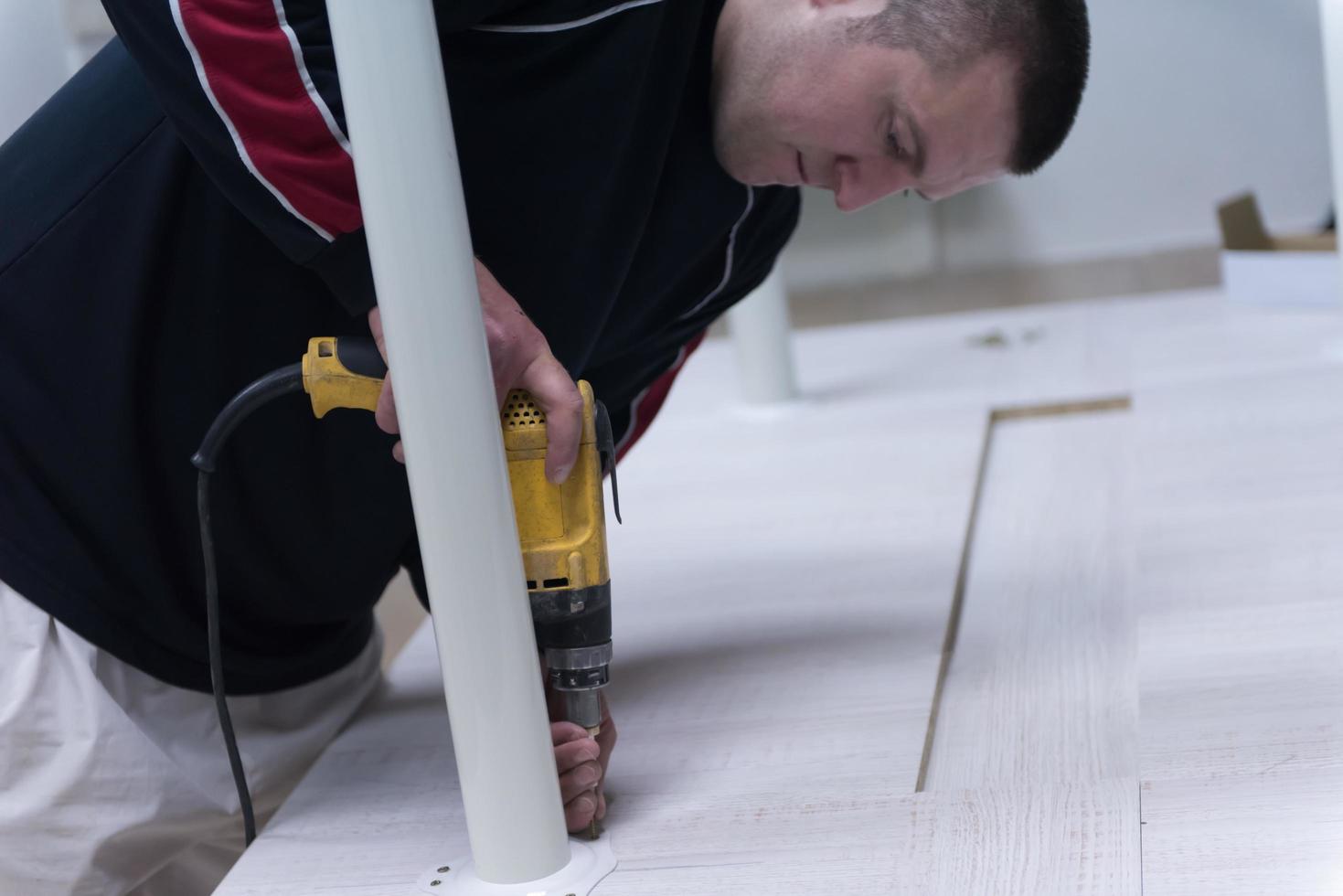 repairman working with drilling machine photo