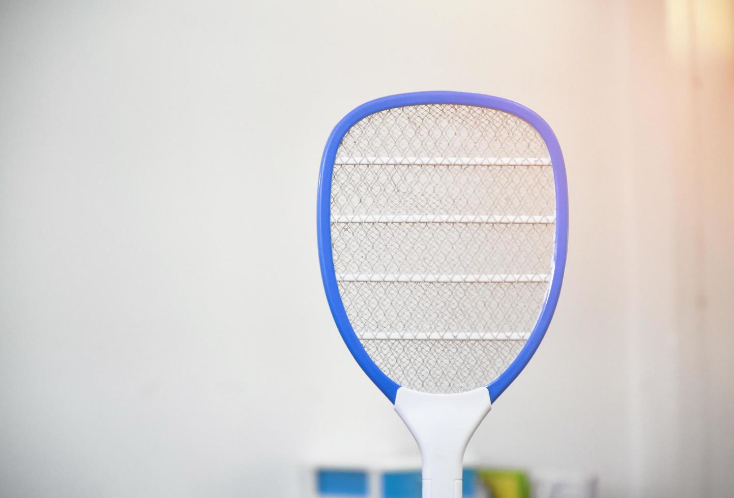 Electronic mosquito swatter in the office room for killing mosquitoes and insects inside the office, soft and selective focus. photo