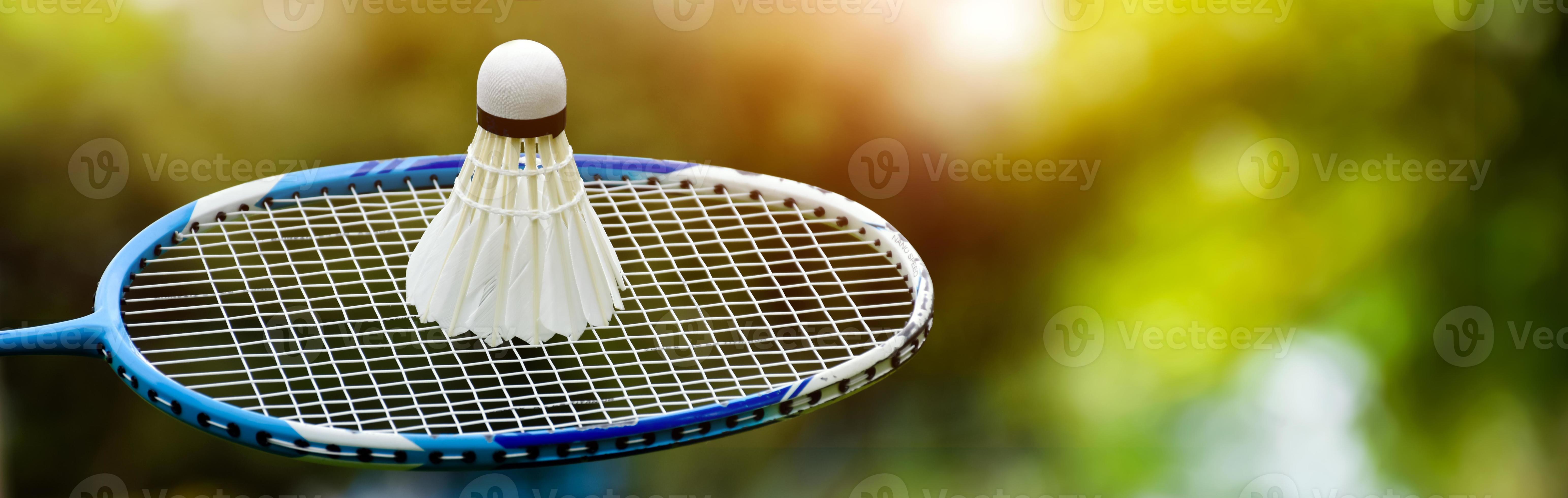 Badminton racket and badminton shuttlecock against cloudy and bluesky