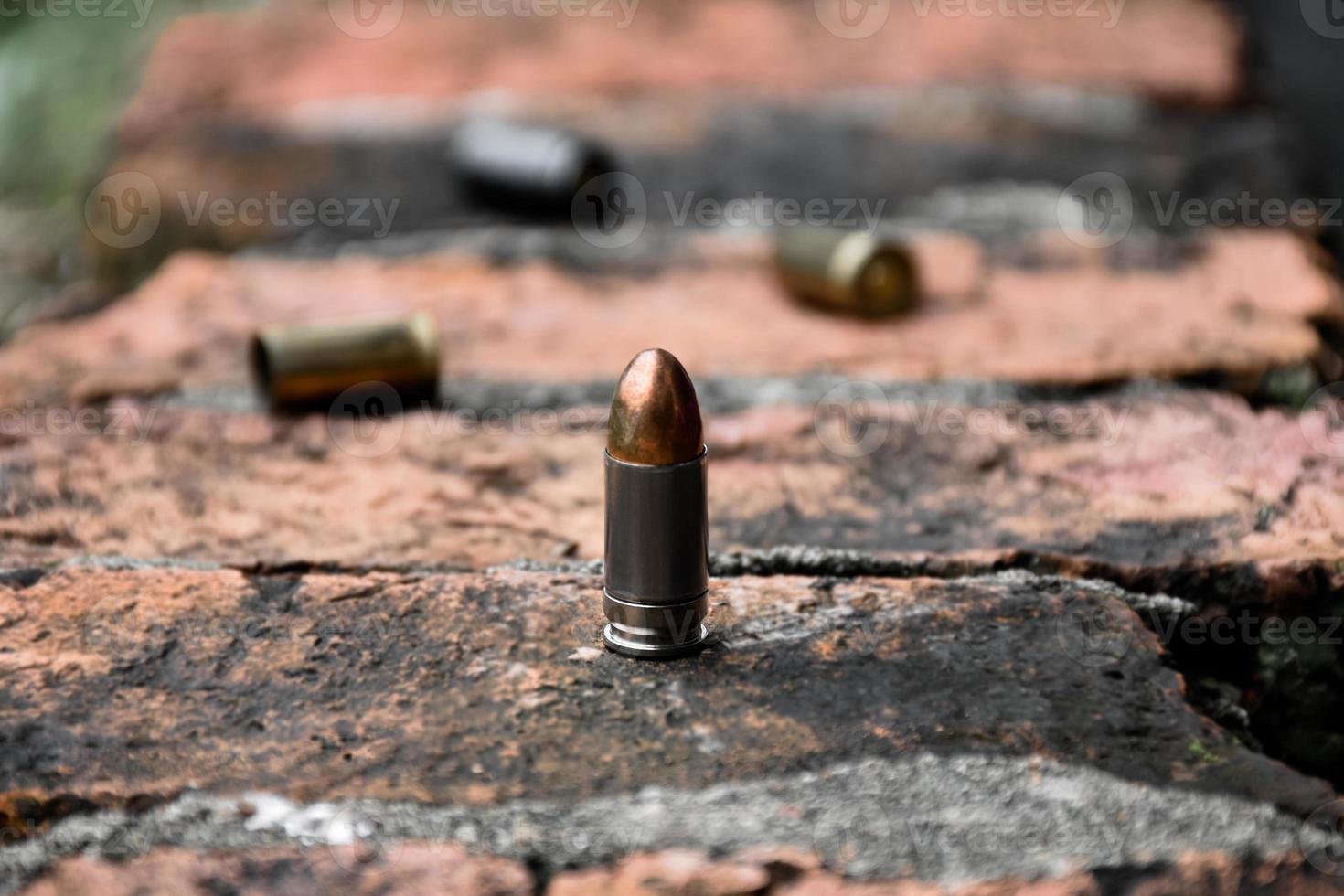 9mm pistol bullet shells on brick floor, soft and selective focus, concept for searching a key piece of evidence in a murder case at the scene. photo