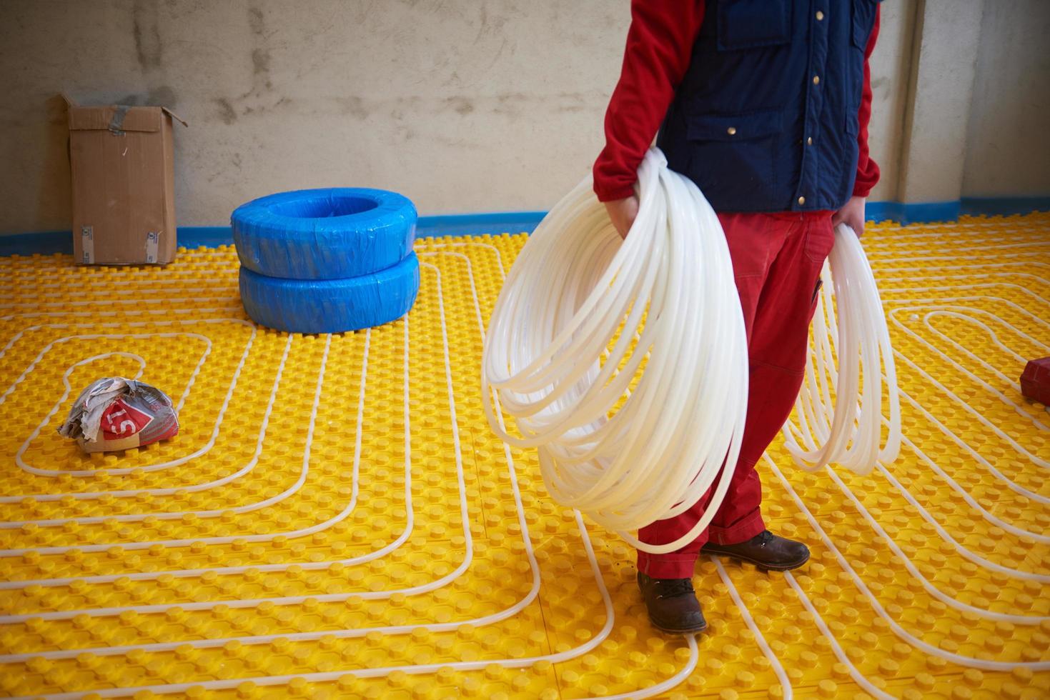 workers installing underfloor heating system photo