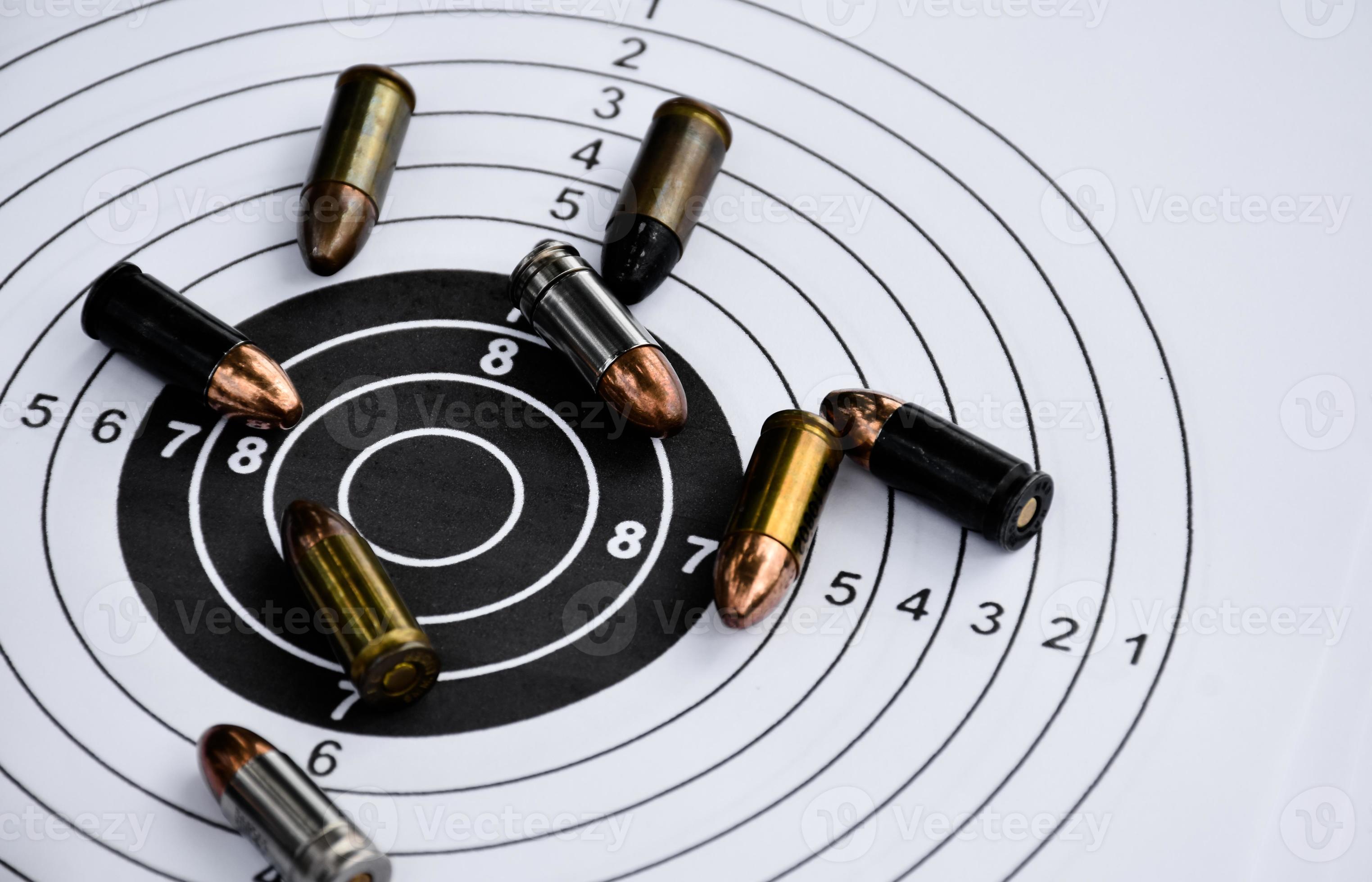 9mm pistol bullets and bullet shells on shooting target papere, soft