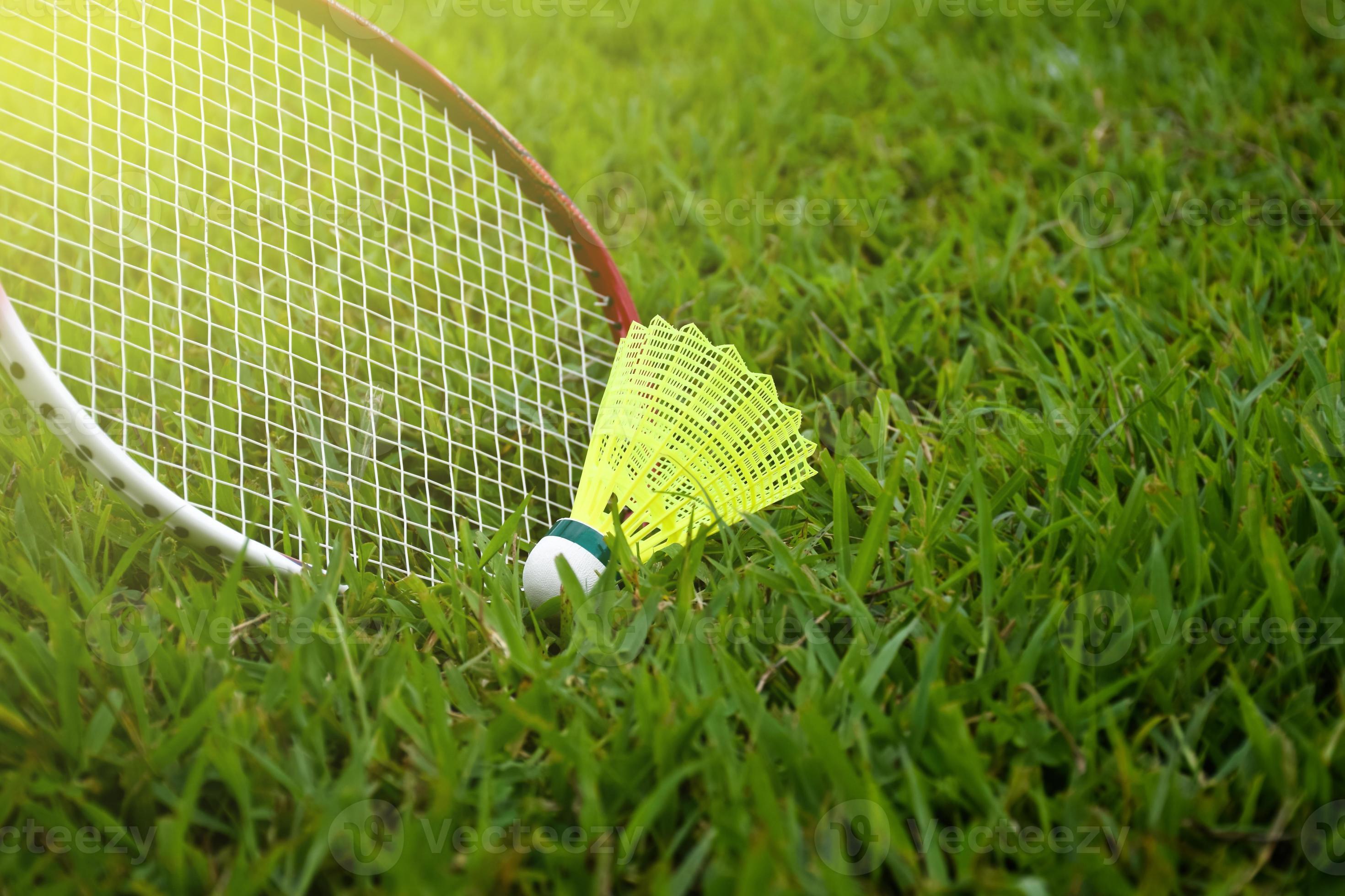 Badminton outdoors equipments shuttlecocks and badminton rackets, on grasslawn, soft and