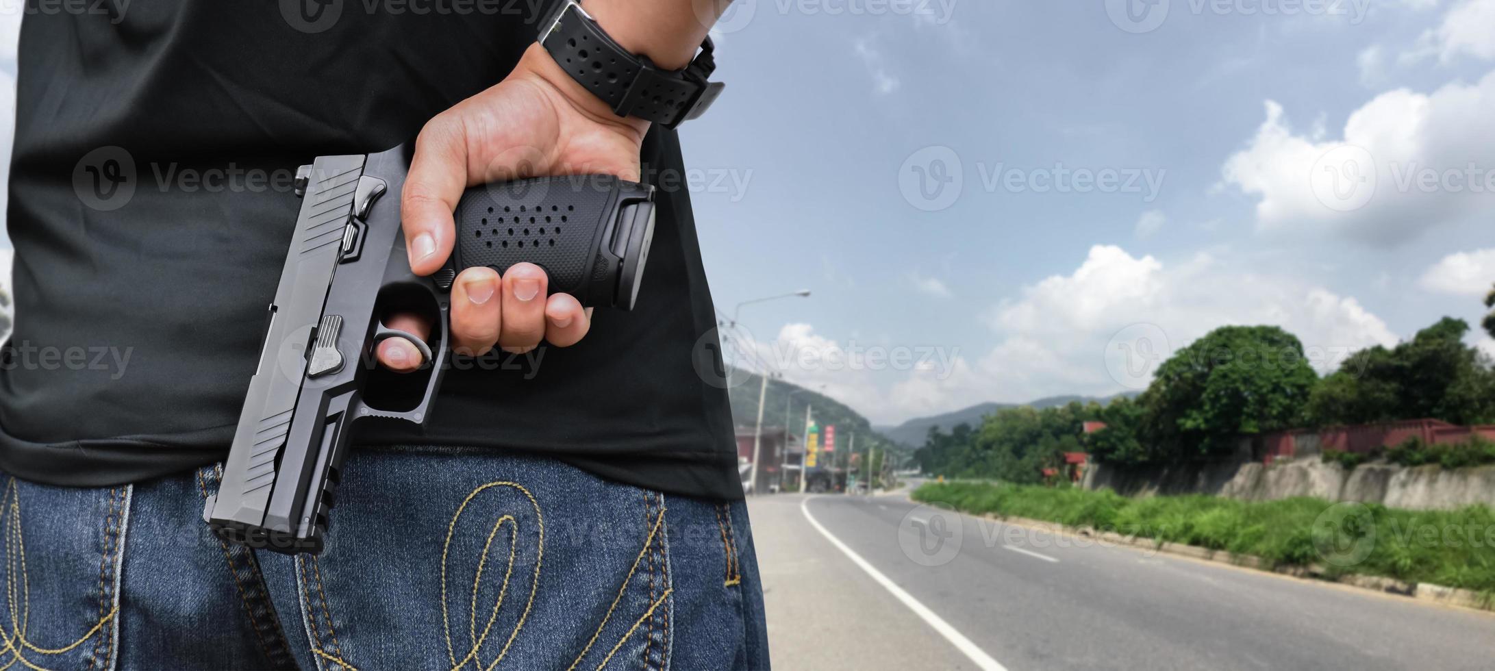 9mm automatic pistol holding in right hand of shooter, concept for security, robbery, gangster, bodyguard around the world. selective focus on pistol. photo