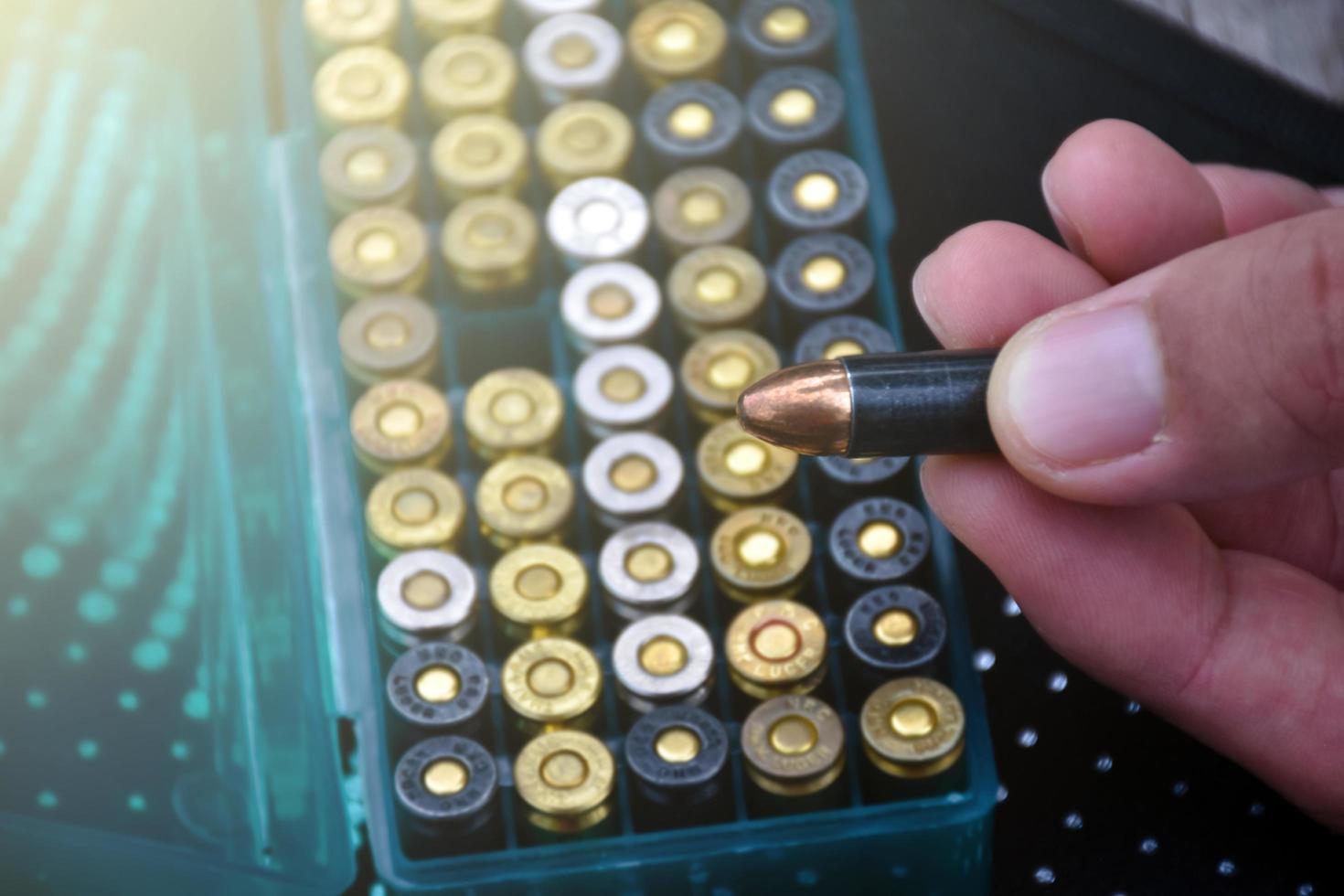 9mm pistol bullets and bullet shells on wooden table, soft and selectivec focus. photo