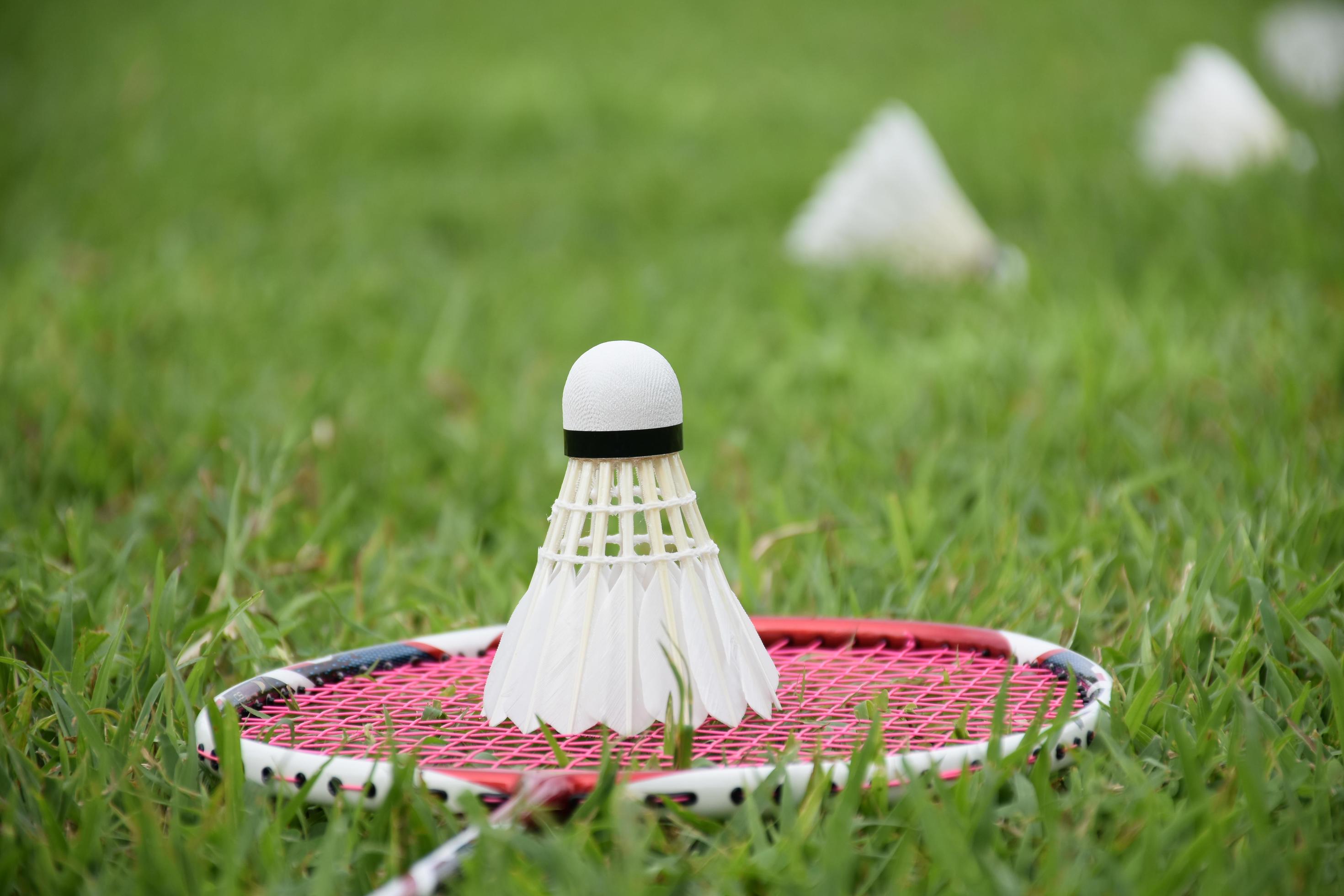 Badminton racket and badminton shuttlecock against cloudy and