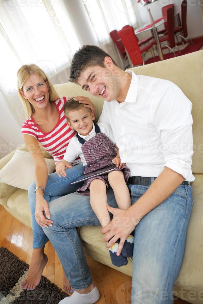 family at home using tablet computer photo