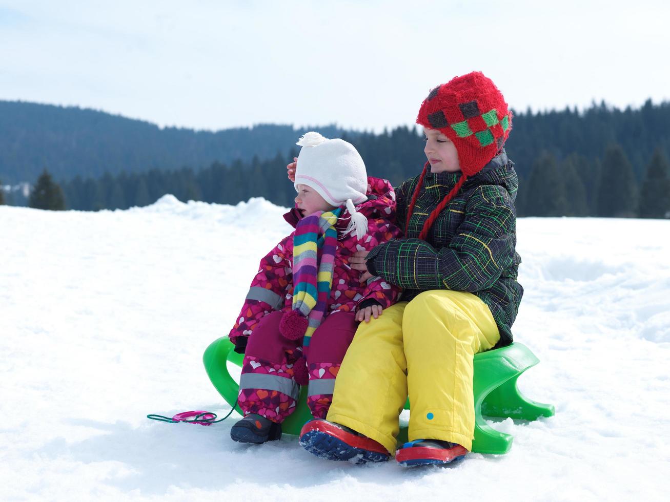 portrait of boy and baby girl on winter vacation photo