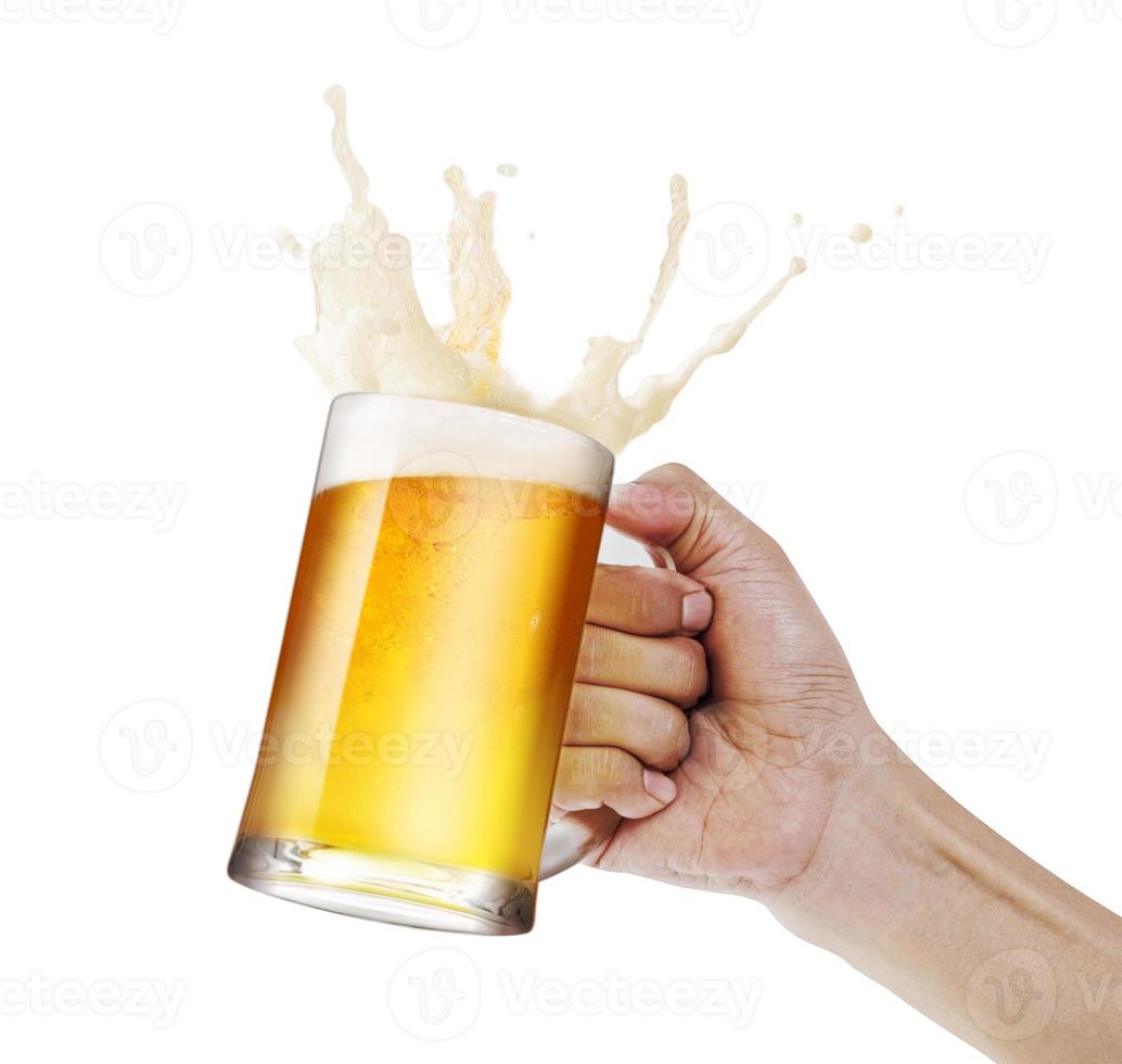 Hand holding a mug of light beer toasting with bubble froth splash isolate white background with copy space photo
