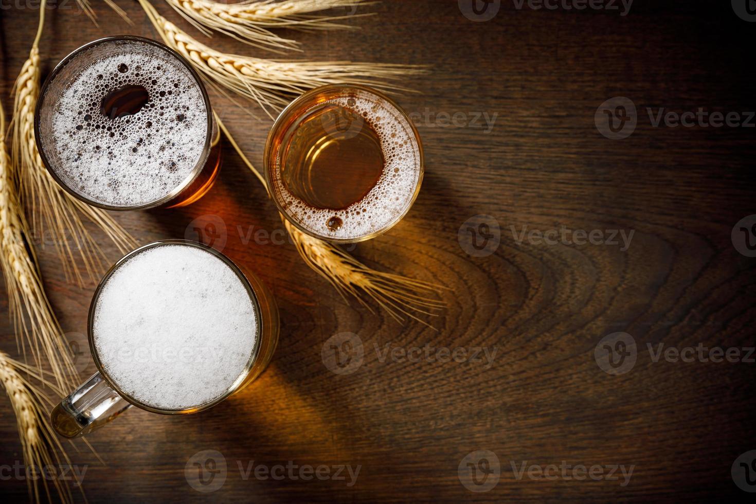 Three Glasses of Light Beer with wheat on the bar counter, copy space for your text photo