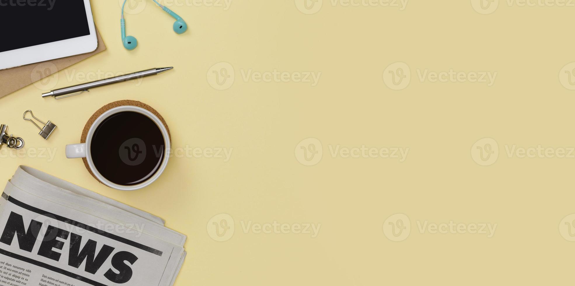 Creative flat lay of office supplies mockup with tablet, newspaper, hot coffee cup, books and accessories isolated on yellow background, Top view with copy space, Workspace for freelancer concept photo