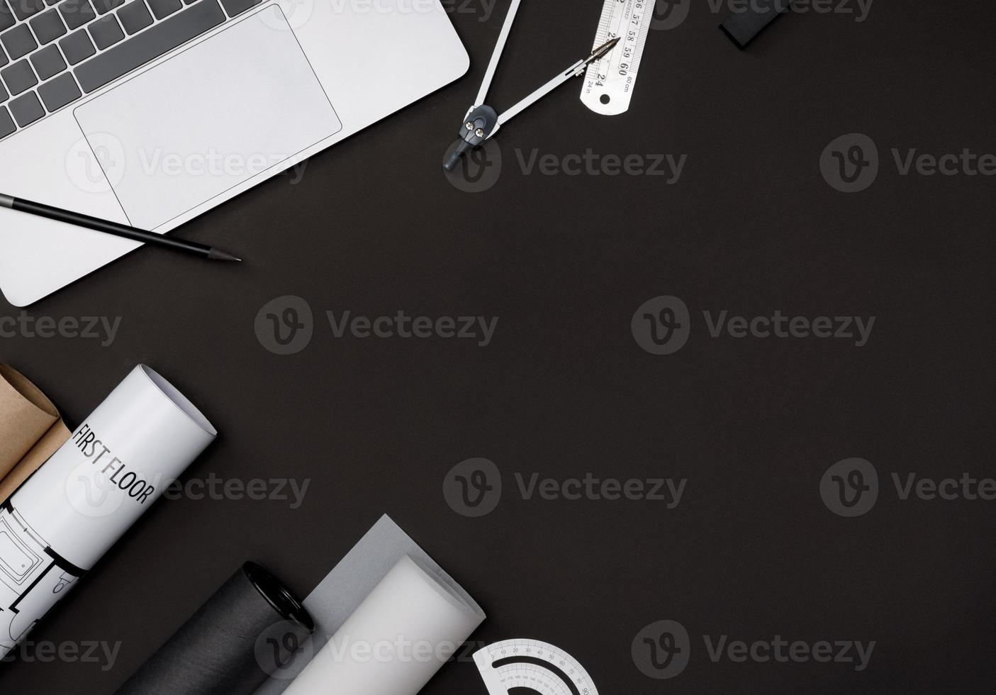 Creative flat lay of architects black table with roll blueprints, architectural project plan, engineering tools, office supplies and laptop computer, Workspace for new designer concept photo