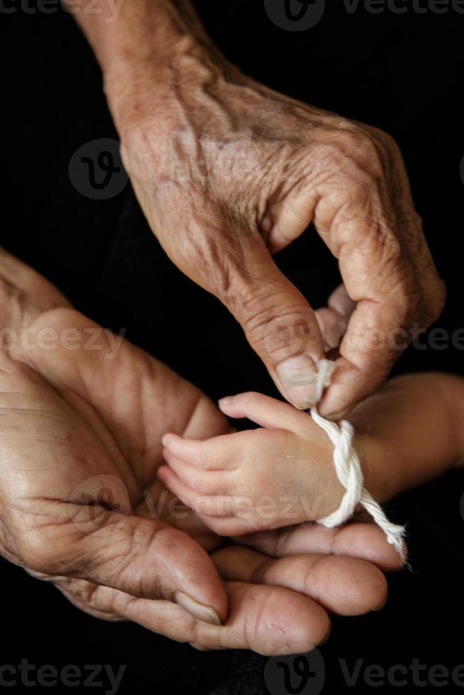 Grandma thread that tied the hands and pray, Lanna Thai Culture photo