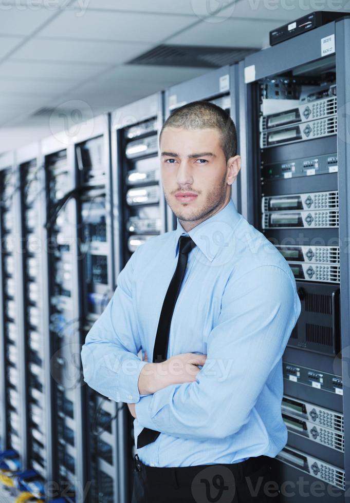 young it engineer in datacenter server room photo