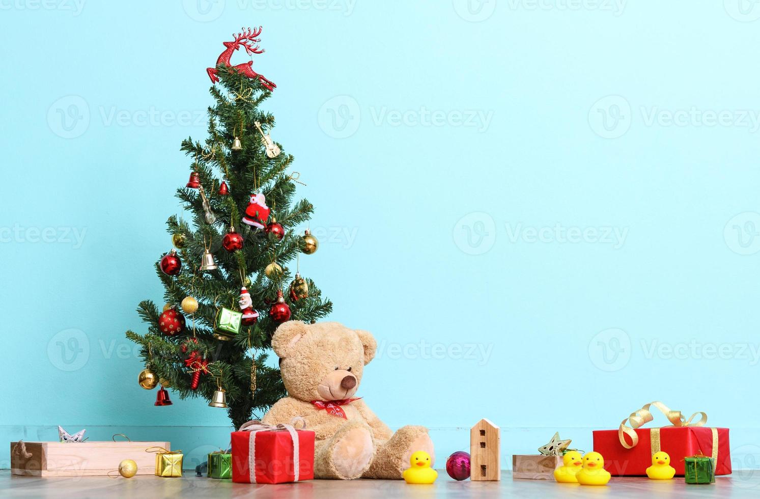 Christmas tree, flag and Christmas decorations with toy teddy bear on blue background, Happy New Year on 2017 with copy space photo