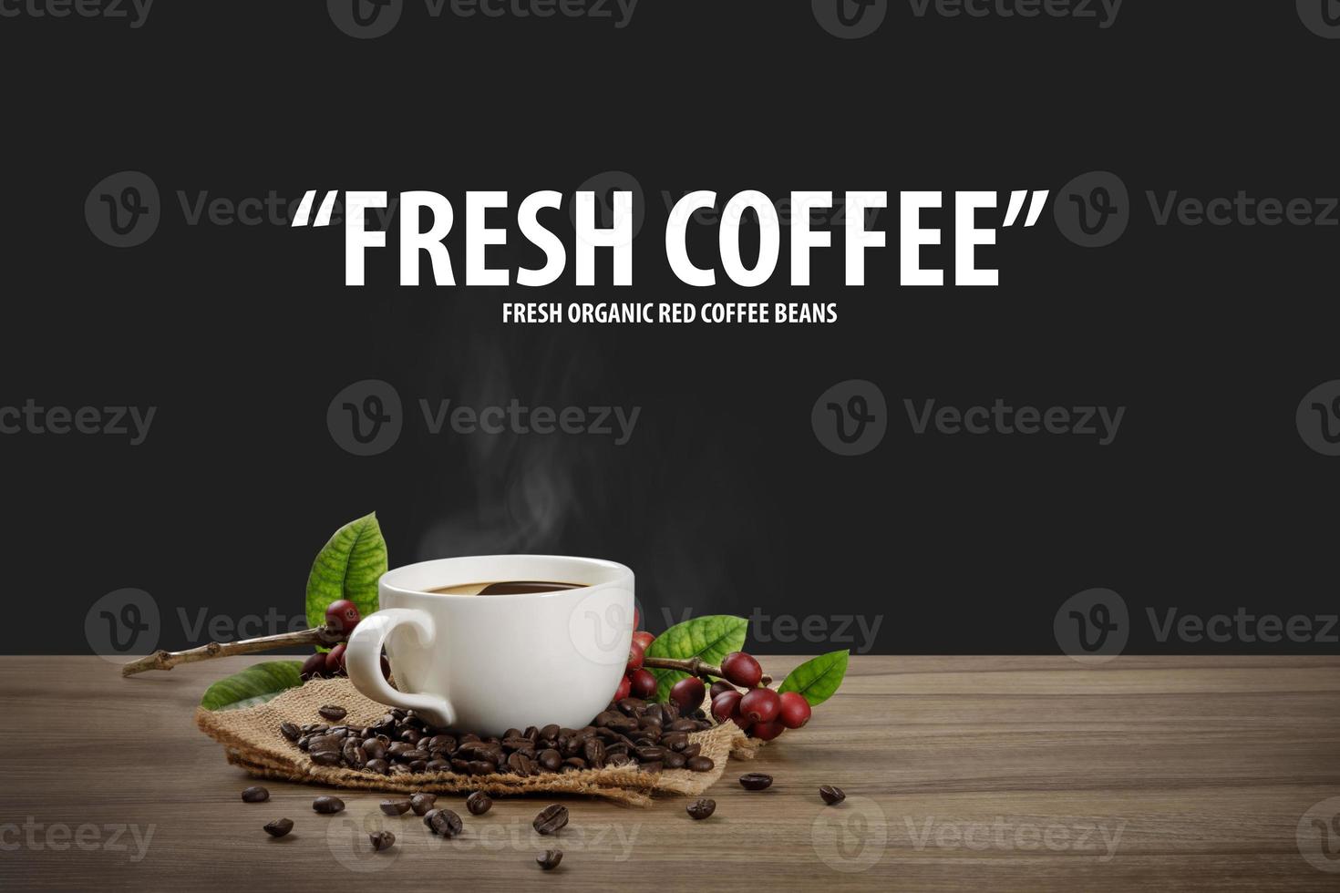 Hot coffee cup with fresh organic red coffee beans and coffee roasts on the wooden table and the black background with copy space for your text. photo