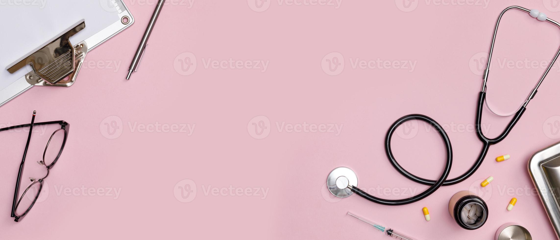 Creative flatlay of doctor medical equipment pink table with stethoscope, medical documents, thermometer, syringe and pills, Health care concept, Top view with copy space for your text photo