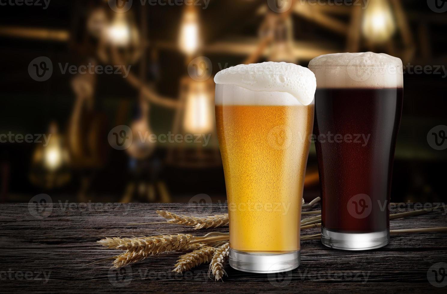 Glasses of Light Beer and Dark Beer with wheat on the bar counter in the restaurant at night, with copy space photo