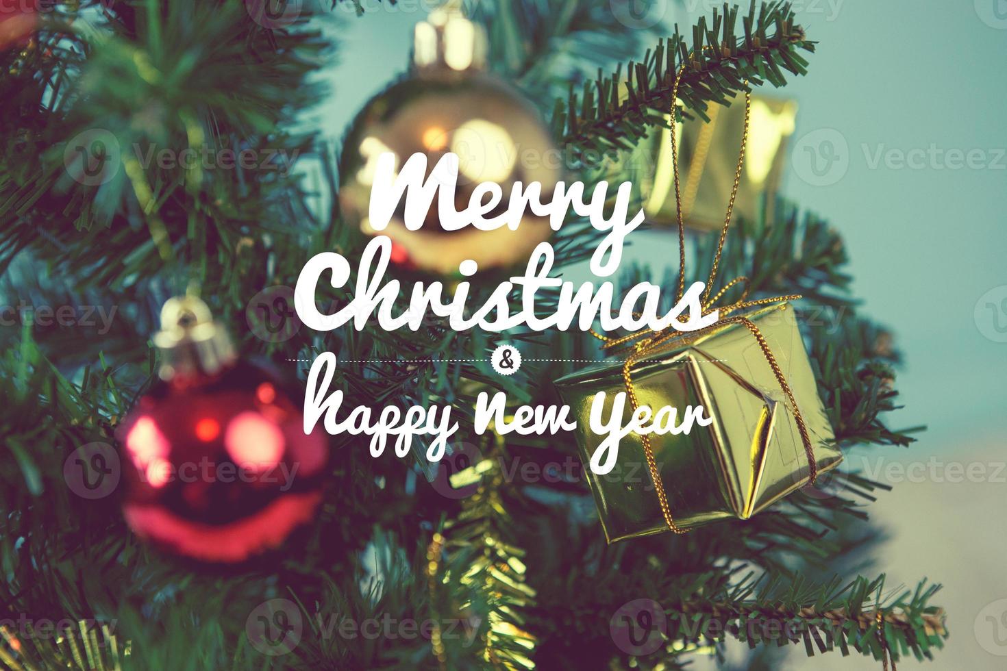 Christmas tree with gifts on green background on blurred, vintage color style and text - Merry Christmas and Happy New Year photo