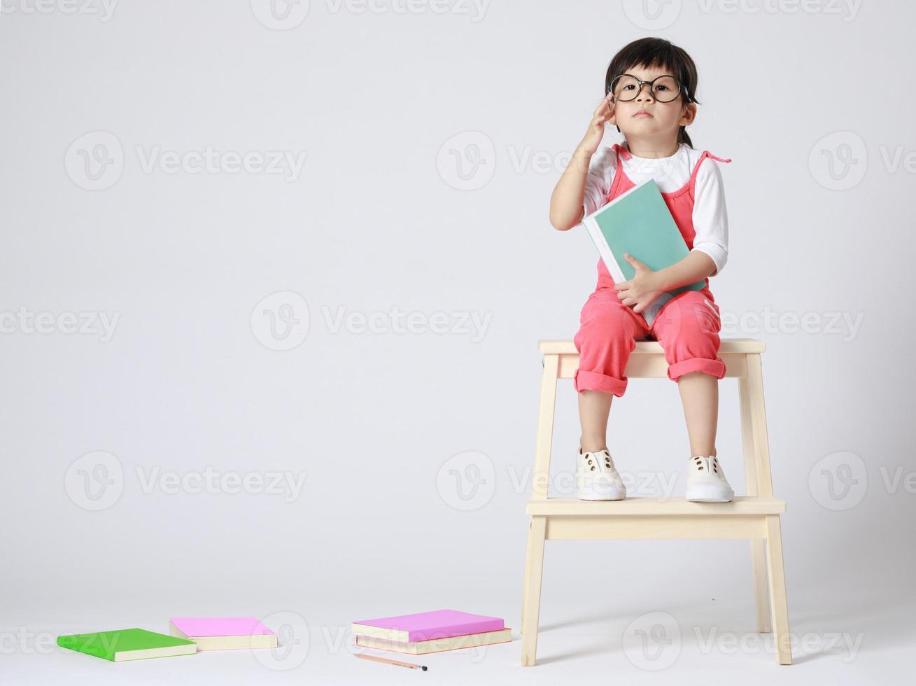 Preschooler girl learns at school. Little girl having fun indoors at home, kindergarten or day care. Educational concept for school kids. photo