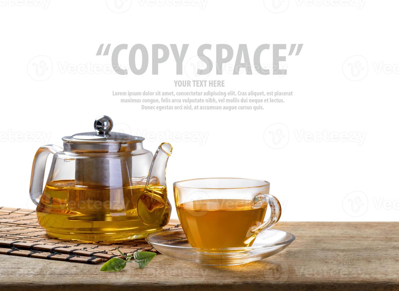 Warm cup of tea and glass jars with organic green tea leaf on wooden table isolate white background with copy space photo