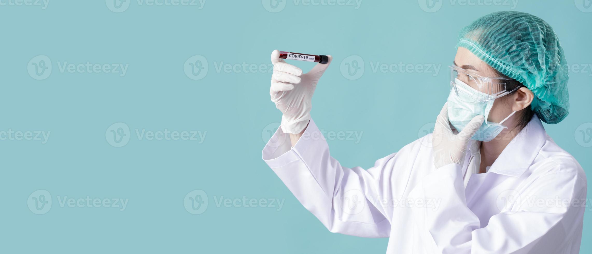 Nurse wearing respirator mask for stop Coronavirus Outbreak COVID-19 and holding testing patients blood samples for Corona Virus from Wuhan China in Laboratory, Empty space isolated on long banner photo