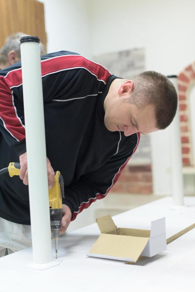 repairman working with drilling machine photo