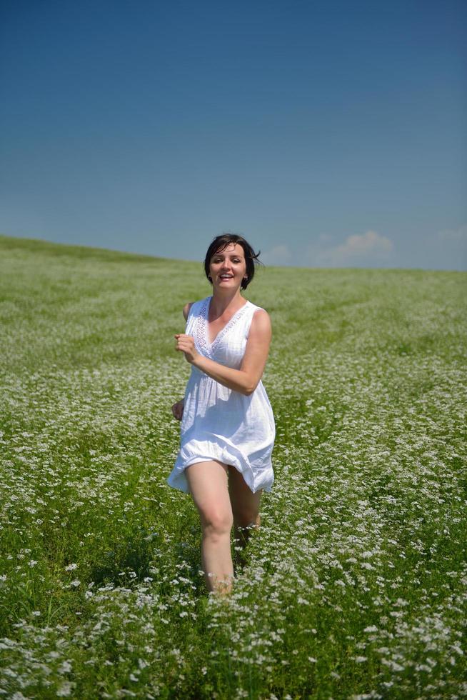 Young happy woman in green field photo