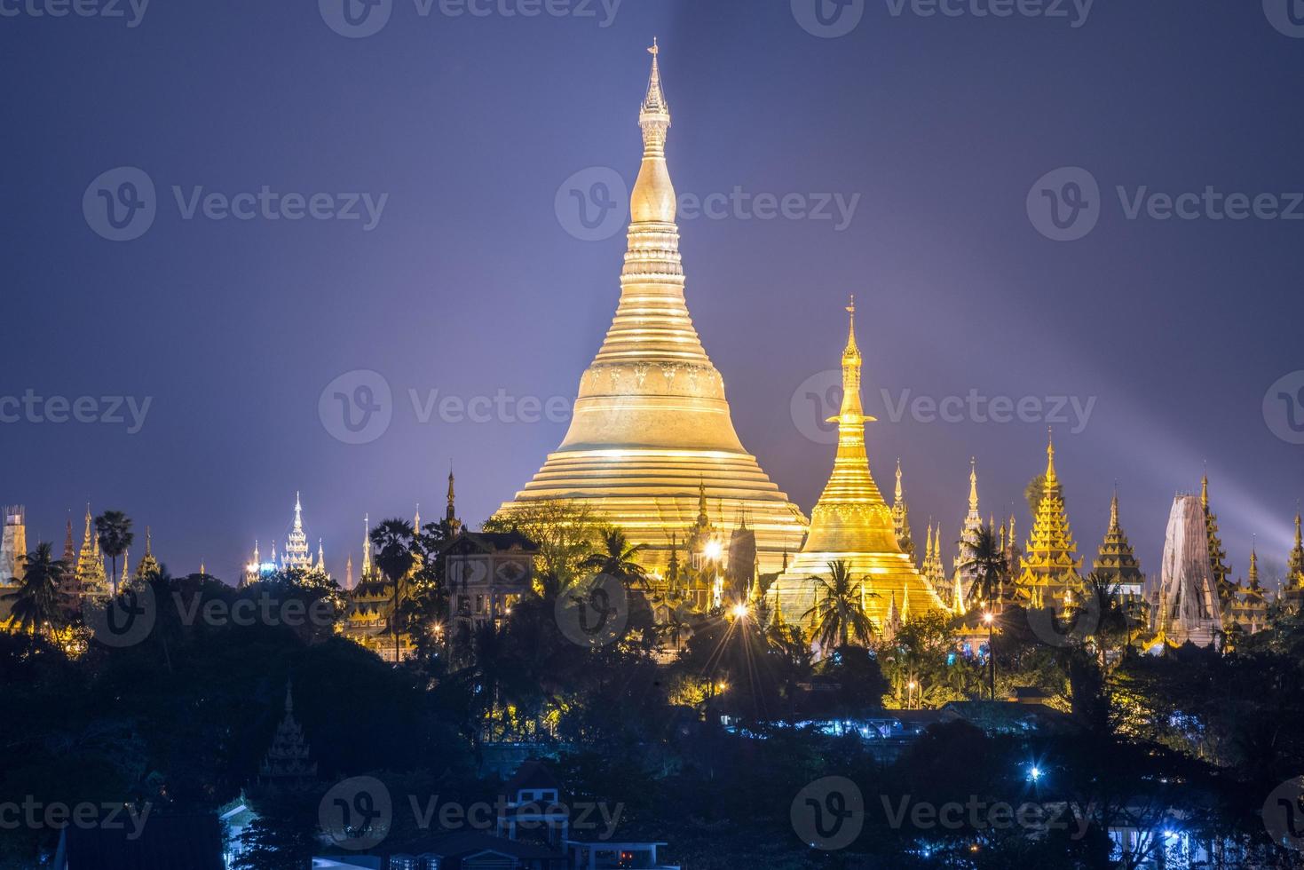 Night view of Shwedagon pagoda the heart of Yangon township of Myanmar. This pagoda it is believed to contain relics of the four previous Buddhas. photo