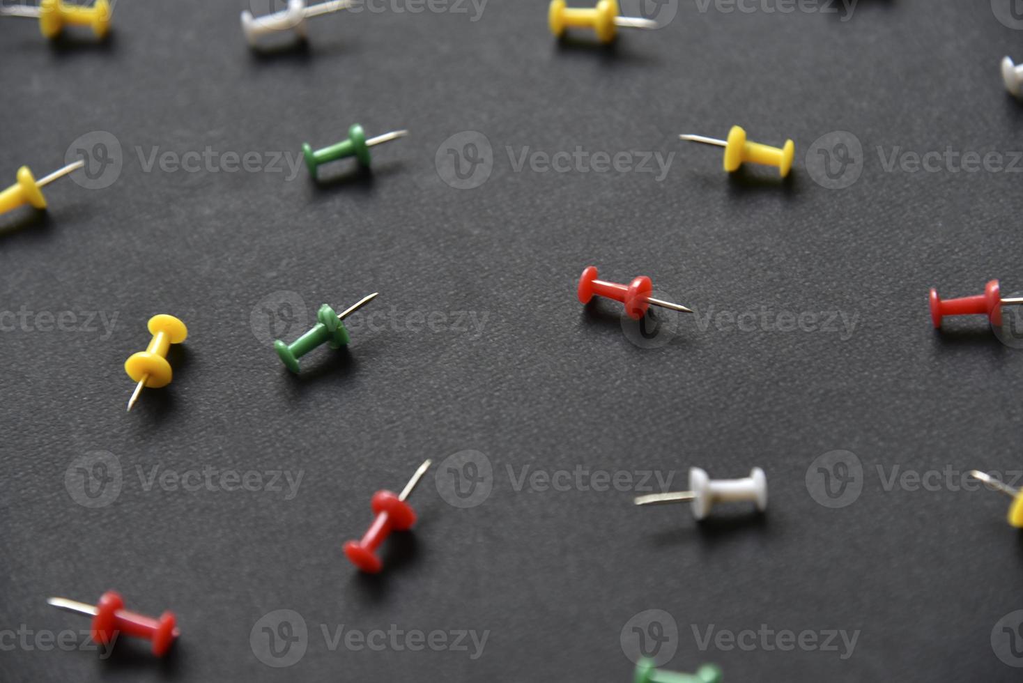 Multicolored plastic power buttons on a black background. Beautiful close-up stationery buttons. photo