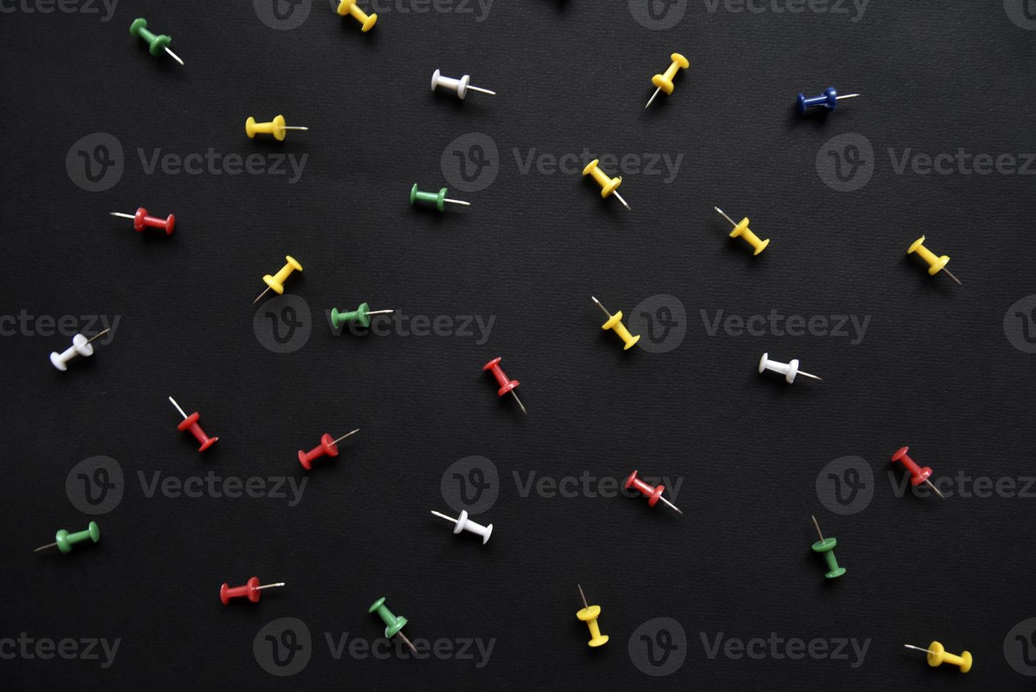 Multicolored plastic power buttons on a black background. Beautiful close-up stationery buttons. photo