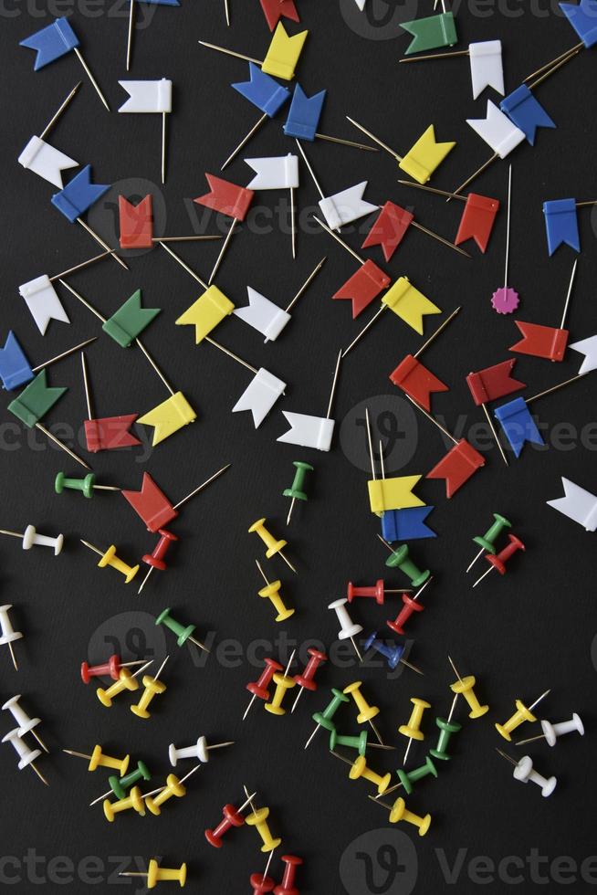 Multicolored plastic power buttons on a black background. Beautiful close-up stationery buttons. photo