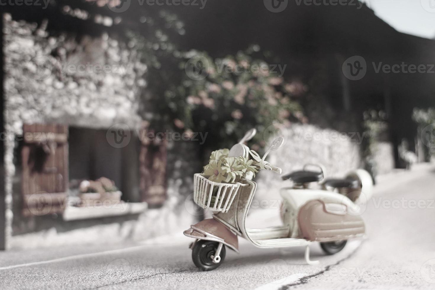 Vintage scooter with flowers on the street photo