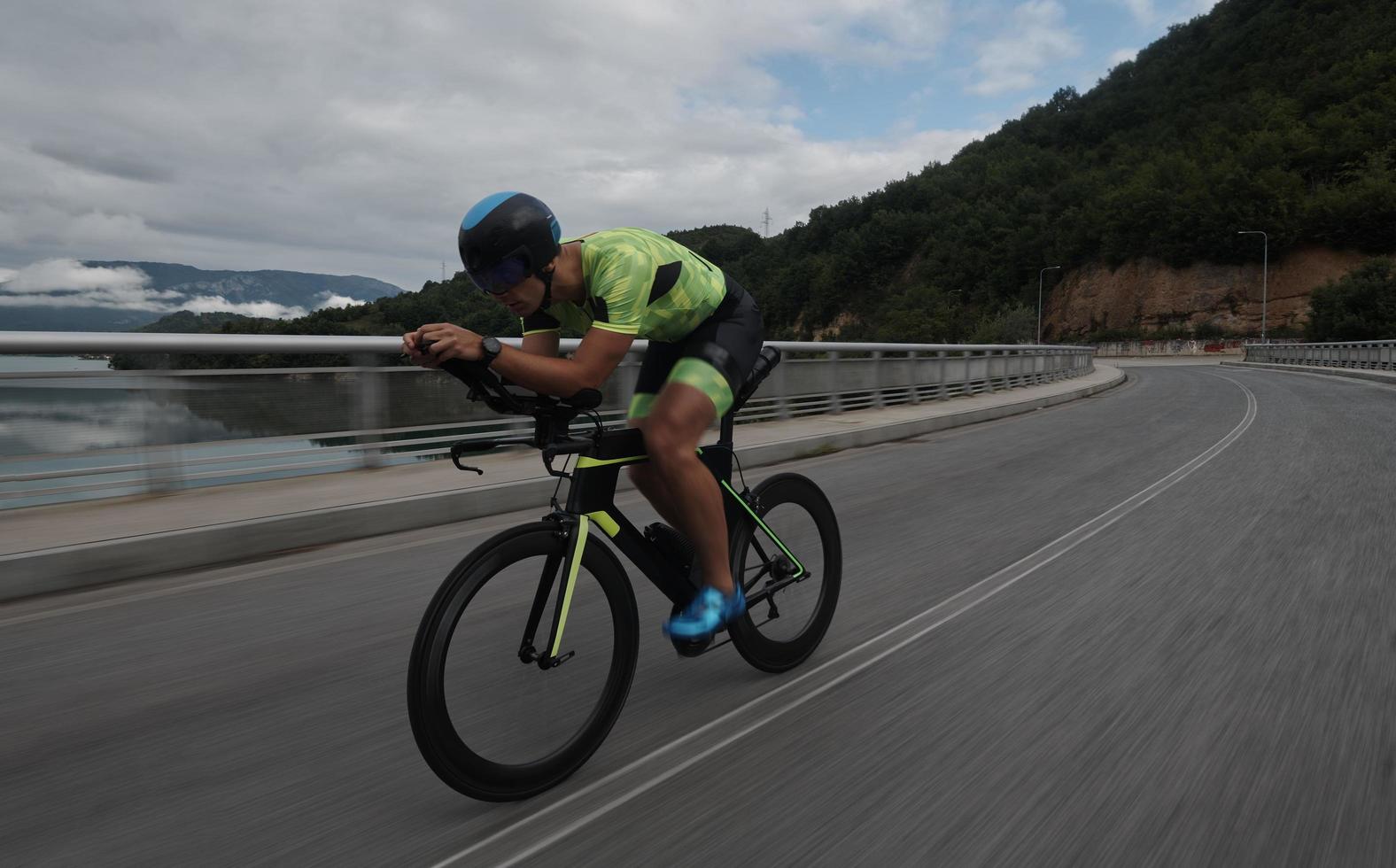 triathlon athlete riding a bike on morning training photo