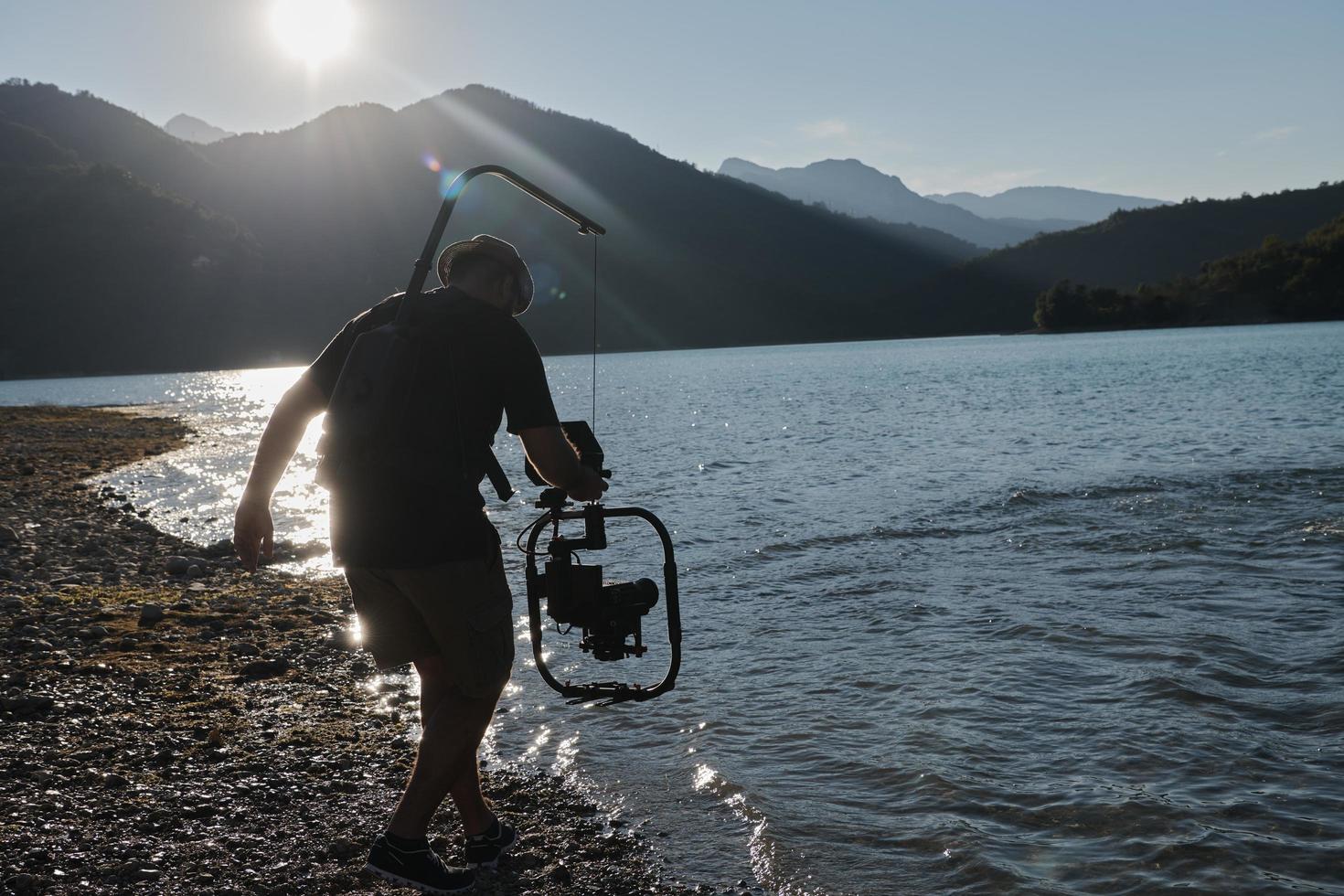 videographer  taking action shot of triathlon swimming athlete photo