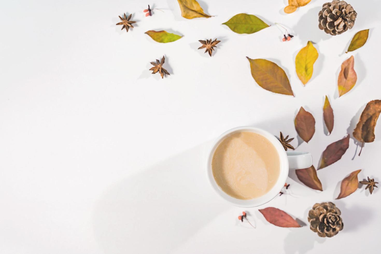 Autumn composition. Cup of coffee, autumn leaves , cinnamon sticks and anise stars on Bright Blue pastel  background. Flat lay, top view copy space. photo