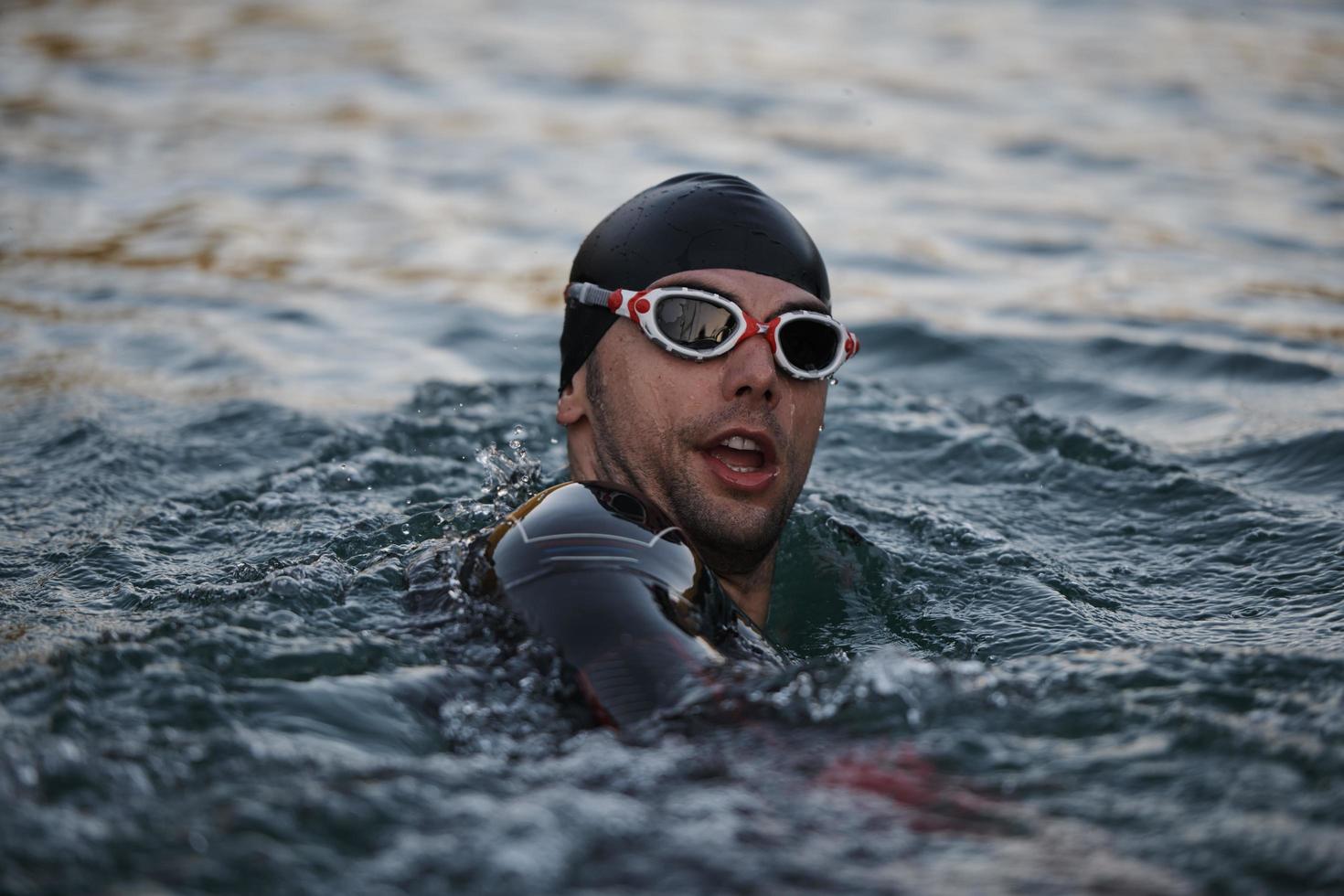 triathlete swimmer having a break during hard training photo