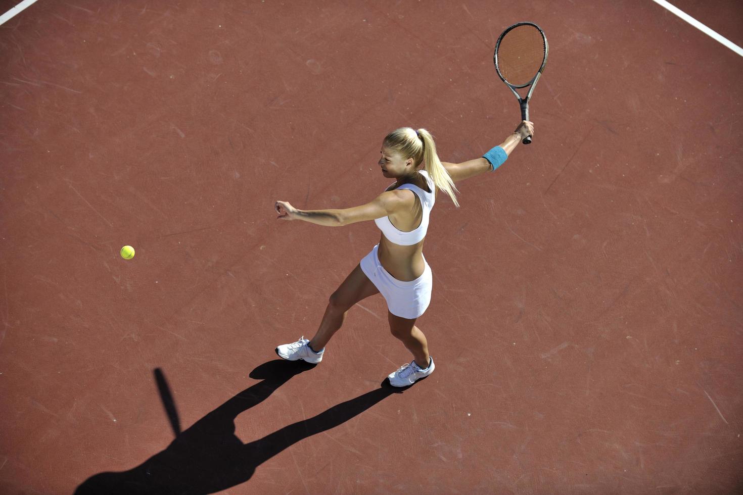 young woman play tennis outdoor photo