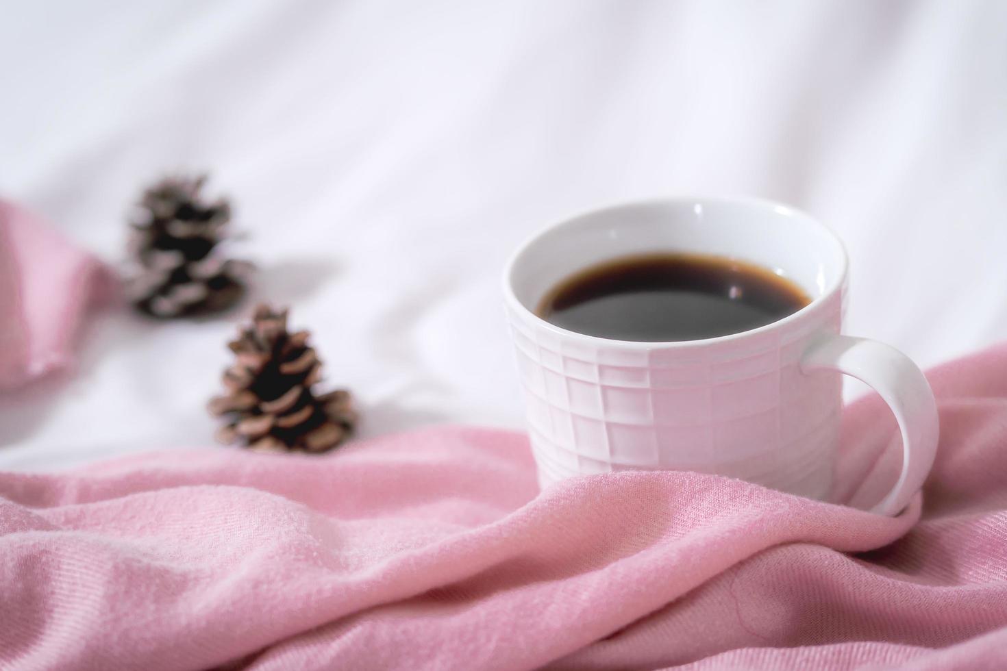 Christmas composition. Cup of coffee, scarf on pink background. Christmas, winter concept. Flat lay, top view, copy space photo