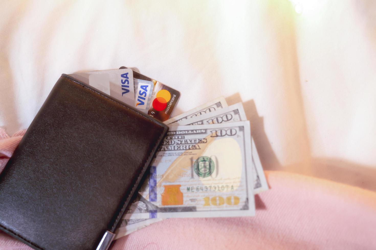 The  pocket money collected in the  Credit card Visa - Mastercard with100 dollar bills money saving growth to profit concept investment and finance business photo