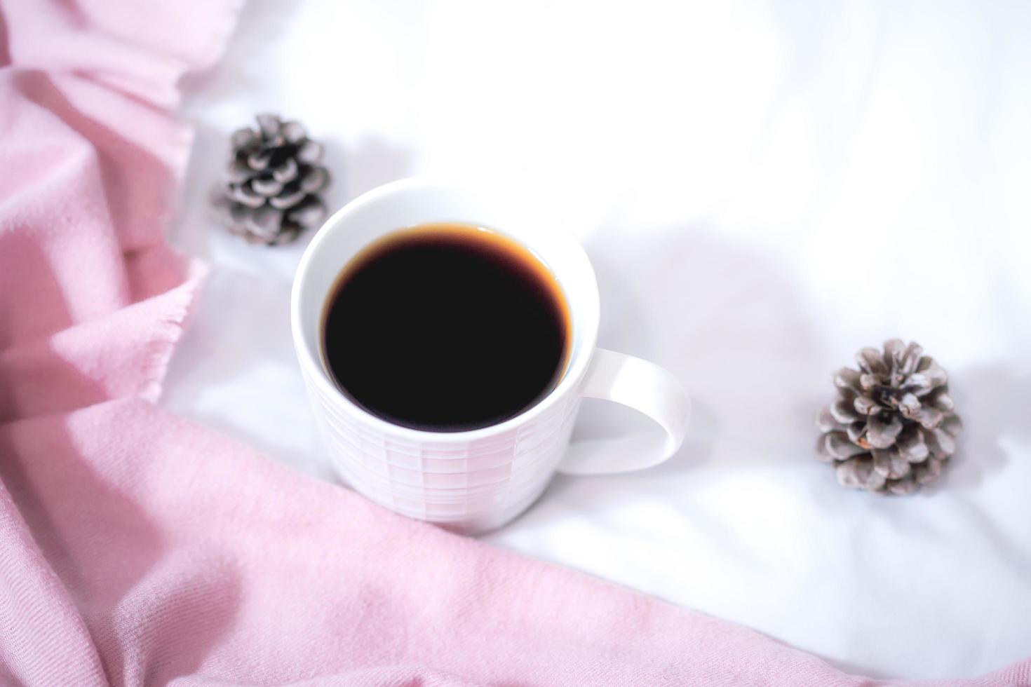 Christmas composition. Cup of coffee, scarf on pink background. Christmas, winter concept. Flat lay, top view, copy space photo